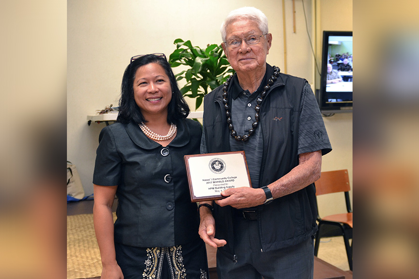 Hawai'i CC Chancellor Rachel Solemsaas presents the Mahalo Award to Robert
