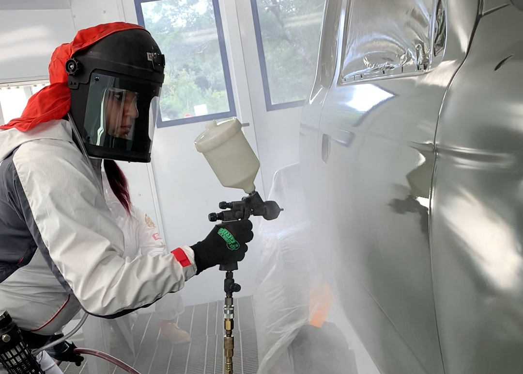 Billie Martines at work in the spray booth at the ABRP shop in Hilo. 