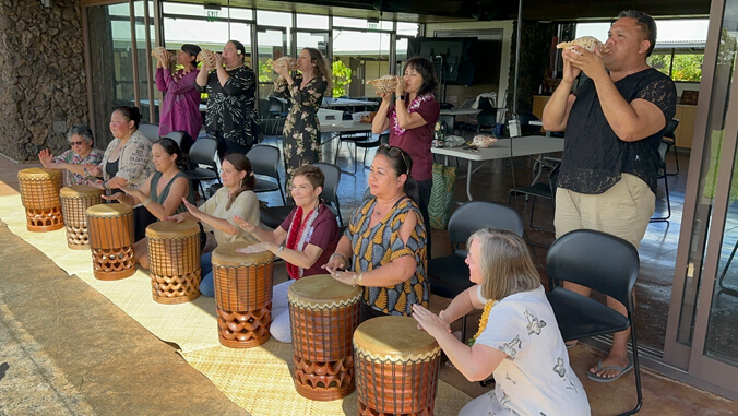 President Hensel takes part in a workshop exploring the elements of the Kīpaepae ceremony. During the session, she learned to hoʻokani the pahu (to drum) and pū (blow the conch shell), discovering the meaning behind this tradition.