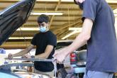 Isaiah Demello, left, and William Roark use a tram gauge to gather point-to-point measurements on a car. 