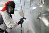 Billie Martines at work in the spray booth at the ABRP shop in Hilo. 