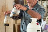 Hawaii CC Agriculture program assistant professor Lew Nakamura mixes fermented plant juice with lactic acid bacteria and water to inoculate the IMO.